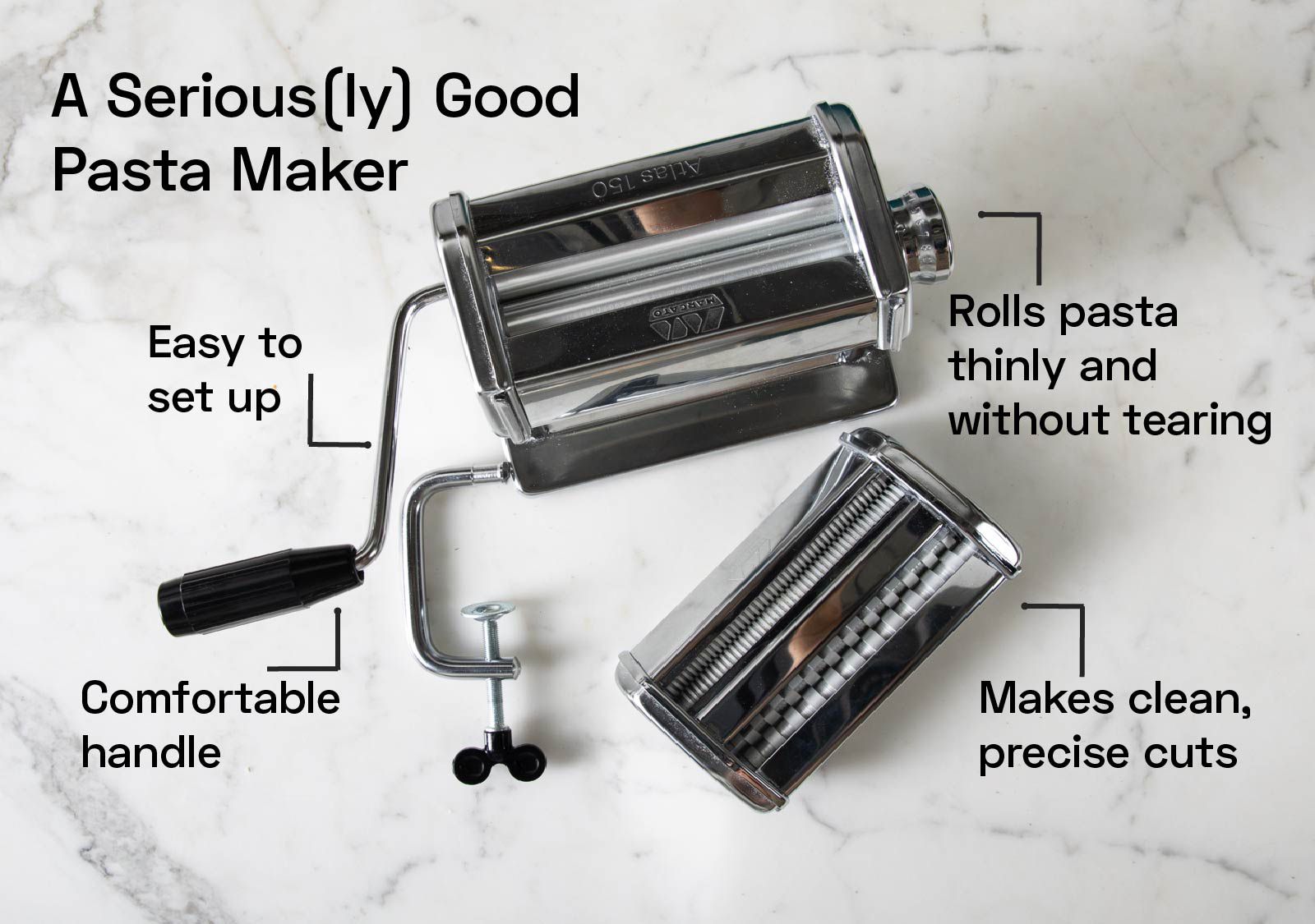 a stainless steel pasta maker on a marble countertop