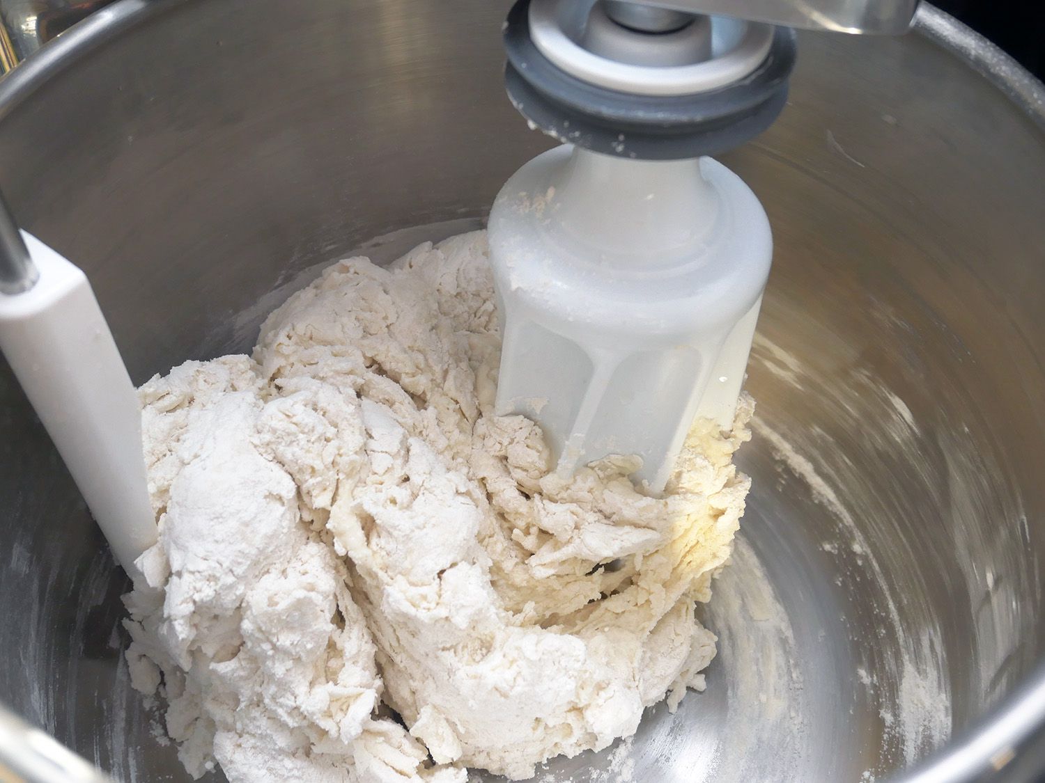 the dough roller and paddle in a bowl kneading bread