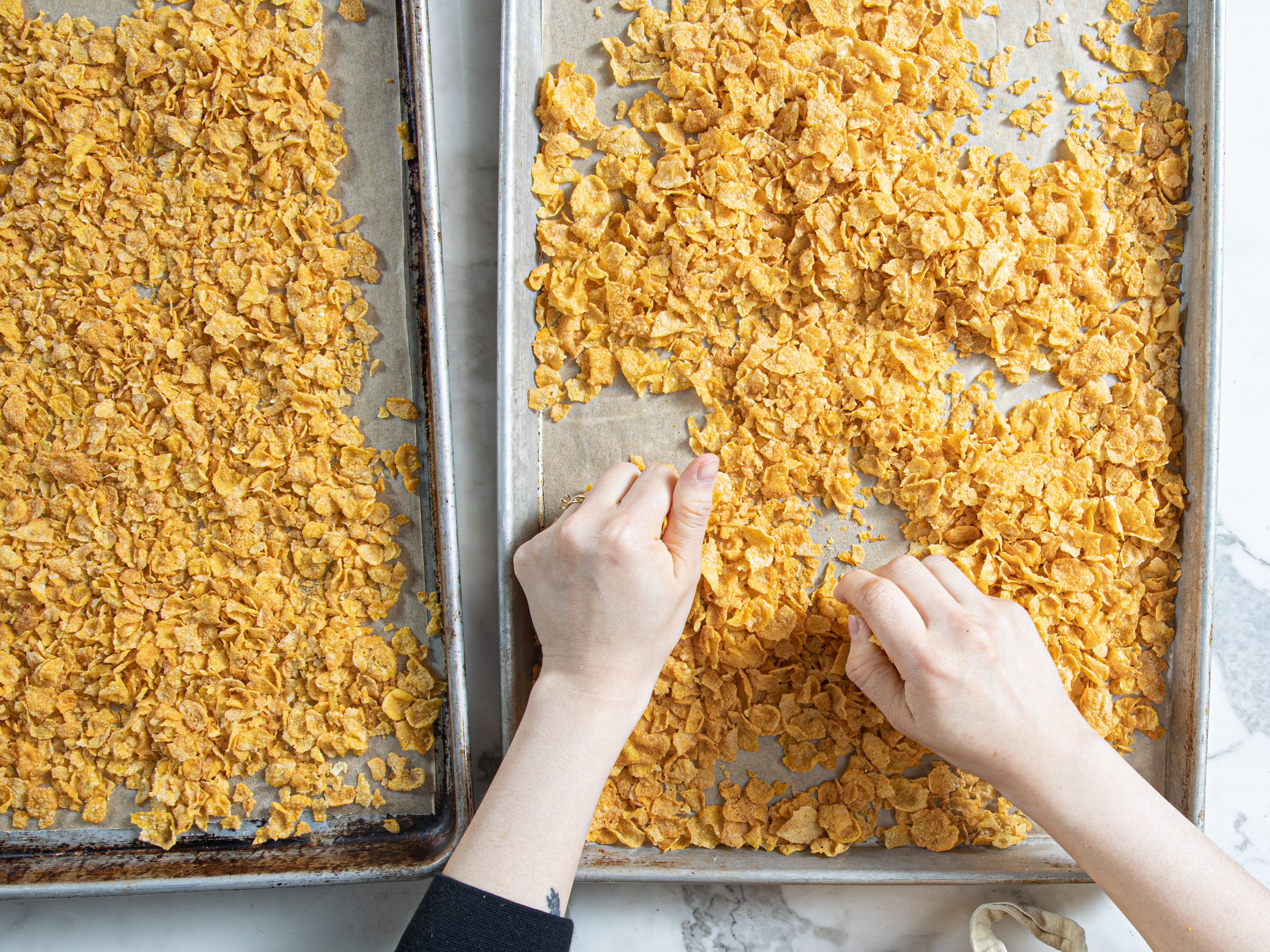 Overhead view of breaking up cornflake rice crispies