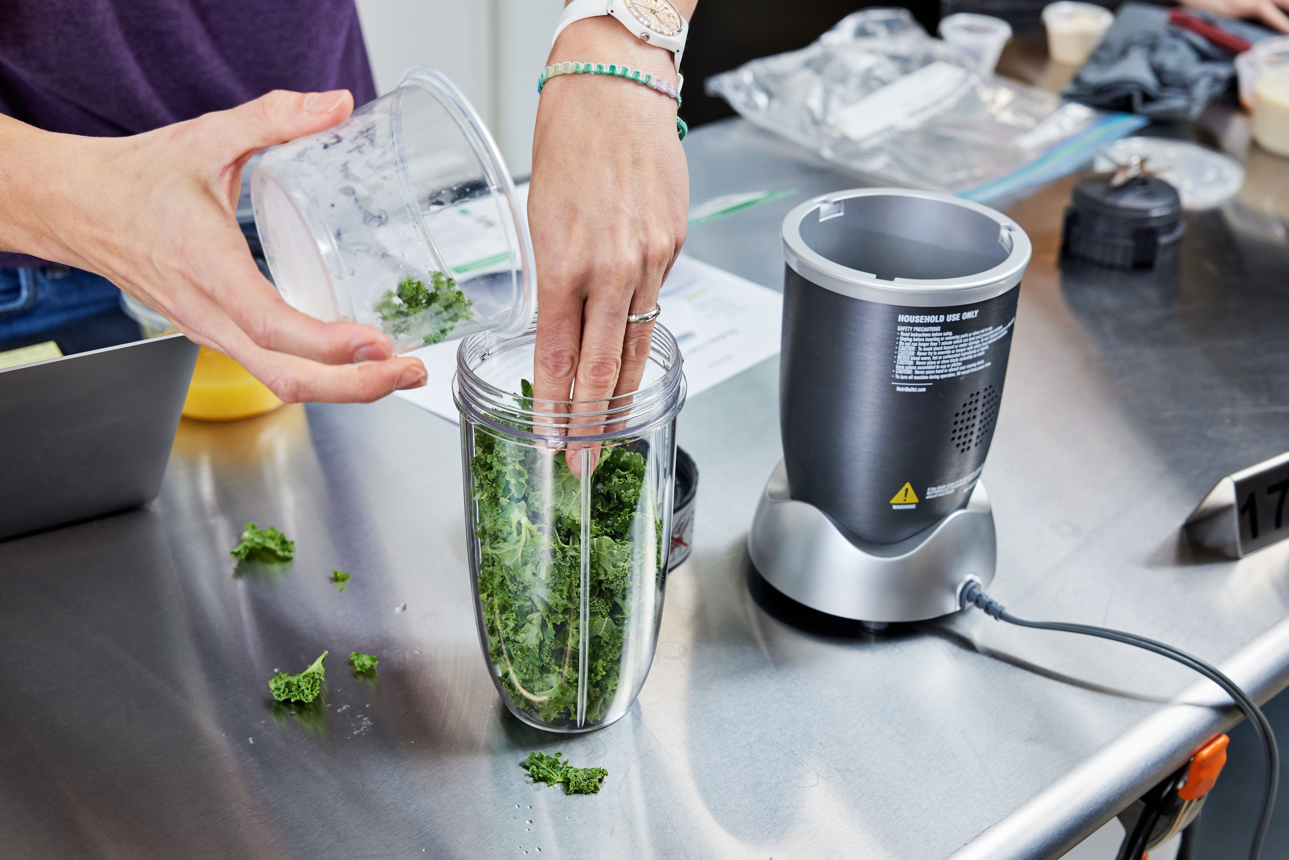 putting kale into the nutribullet pro blender jar