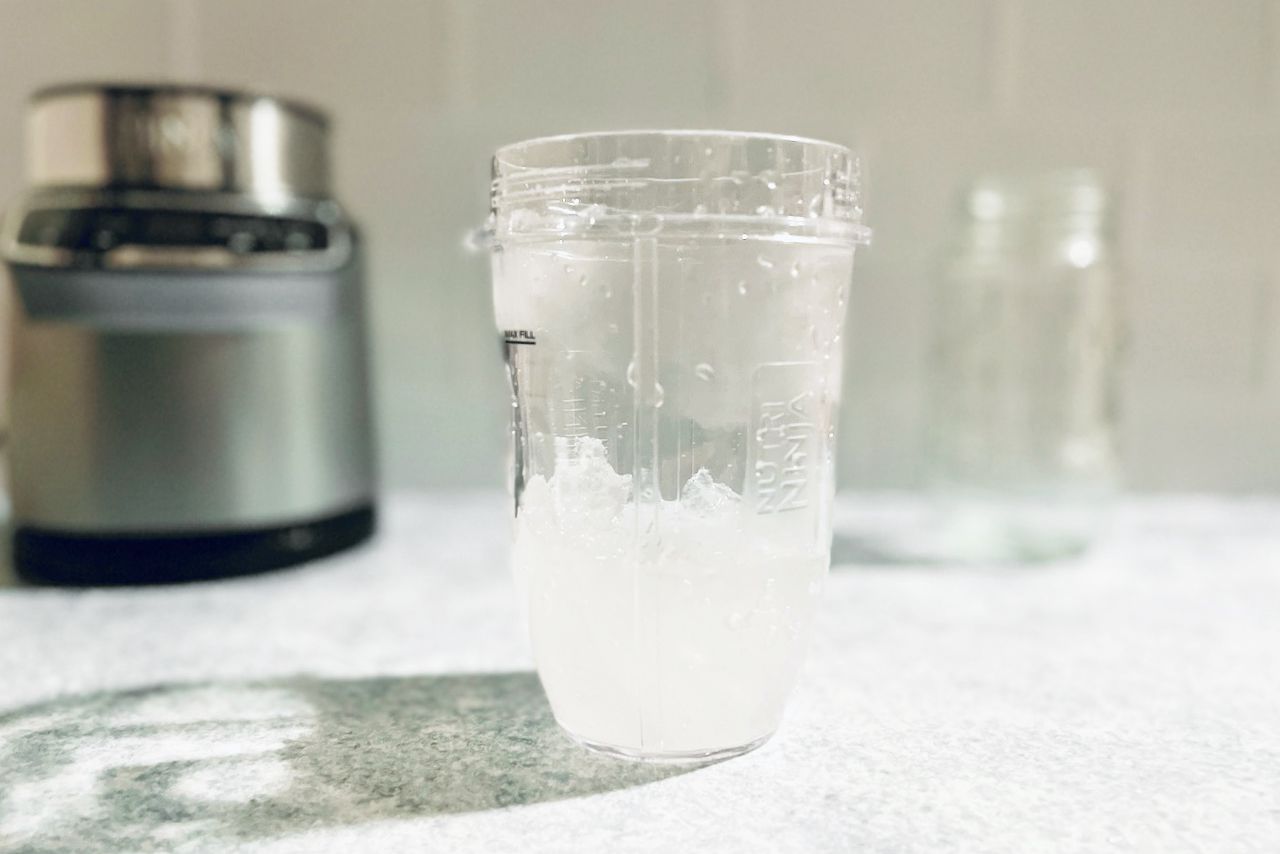 a blender jar with crushed ice inside