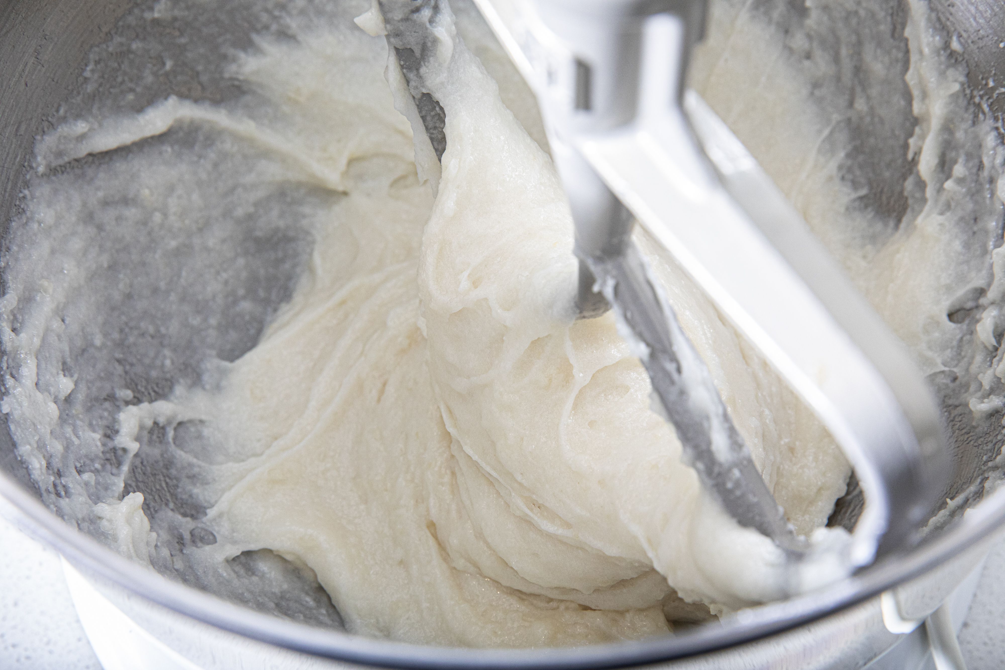 Overhead view of rice being pounded in a stand mixer