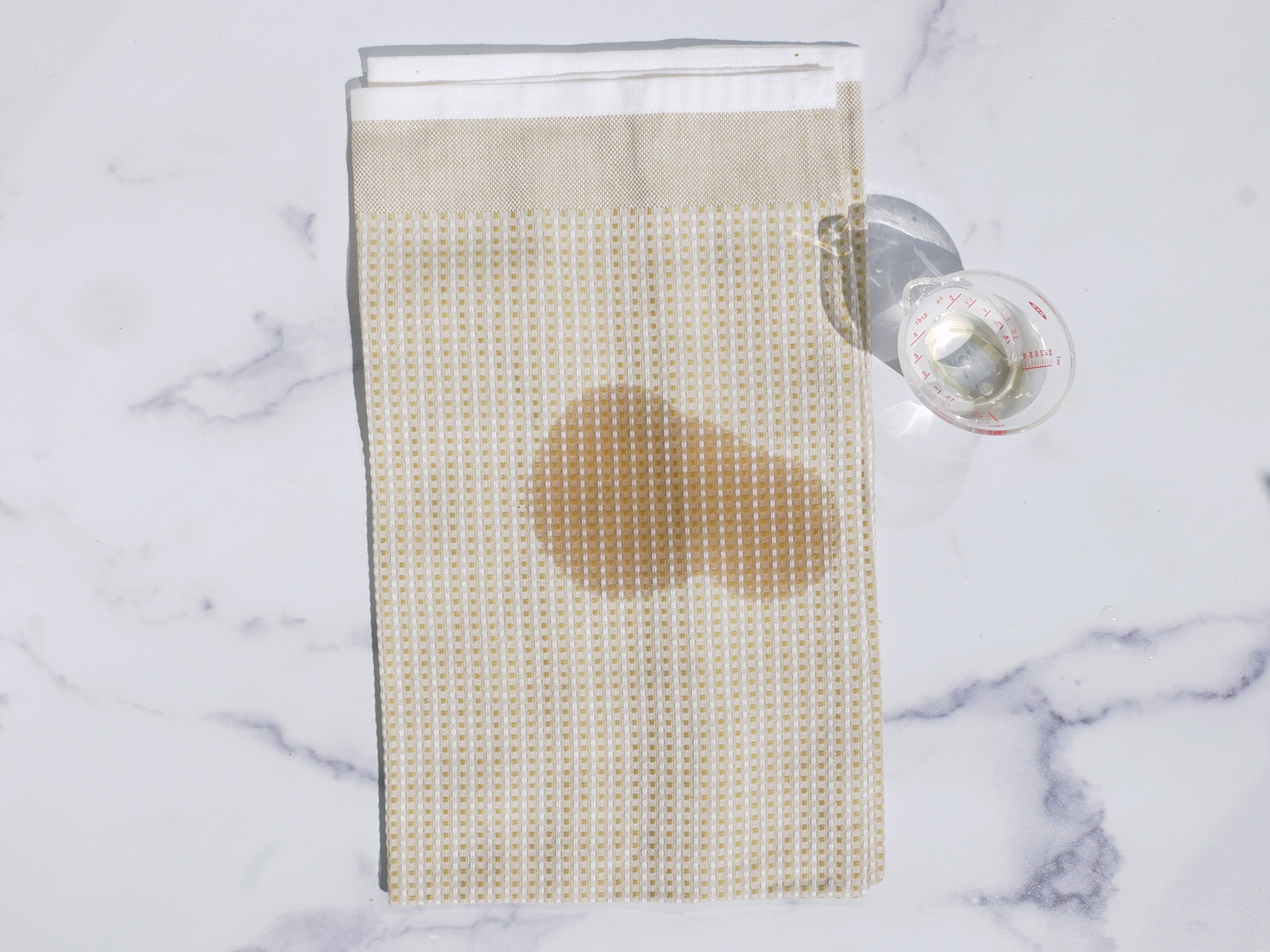 A wet dish towel on a marble surface