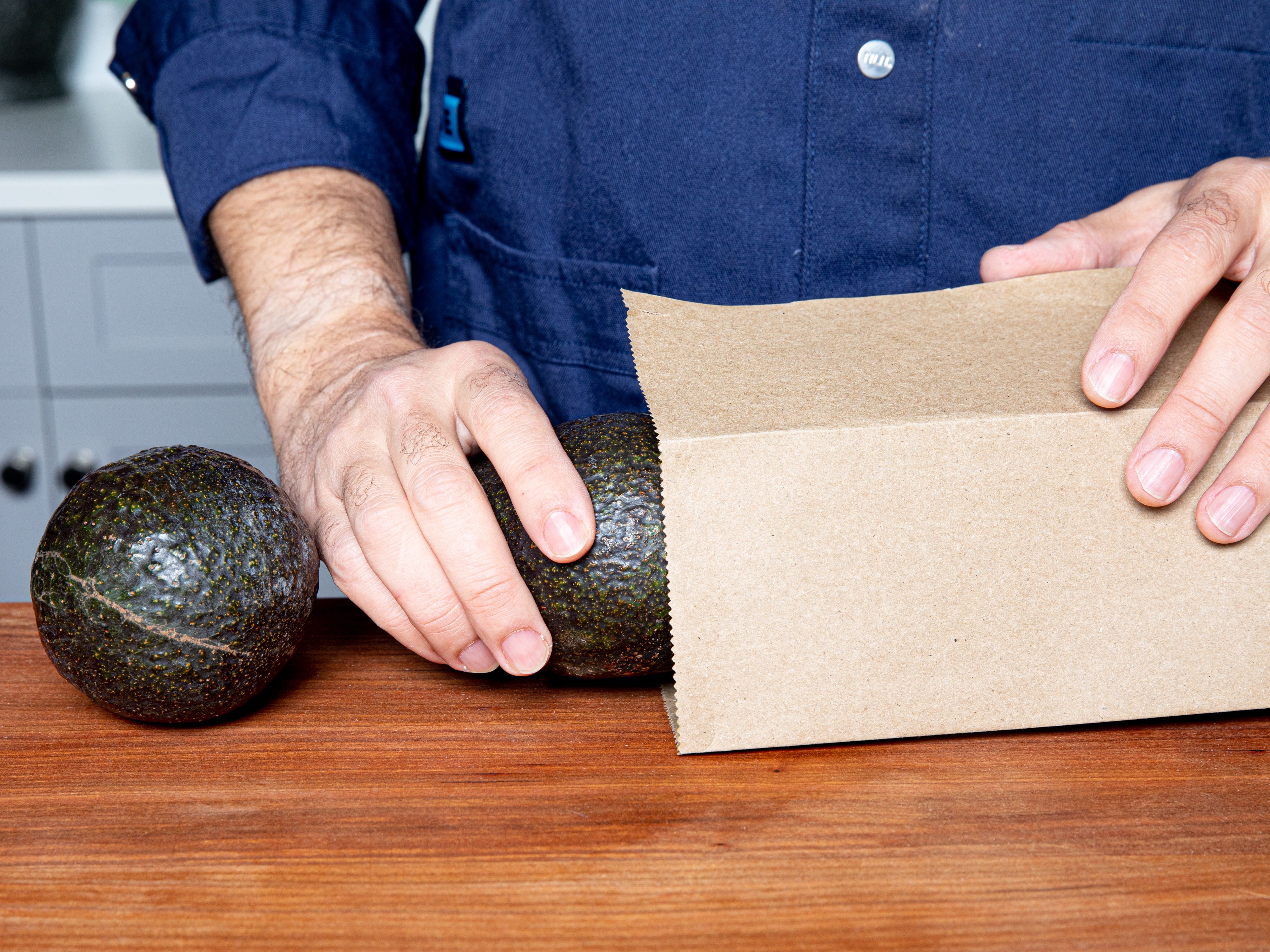 Putting avocados into a brown paper bag