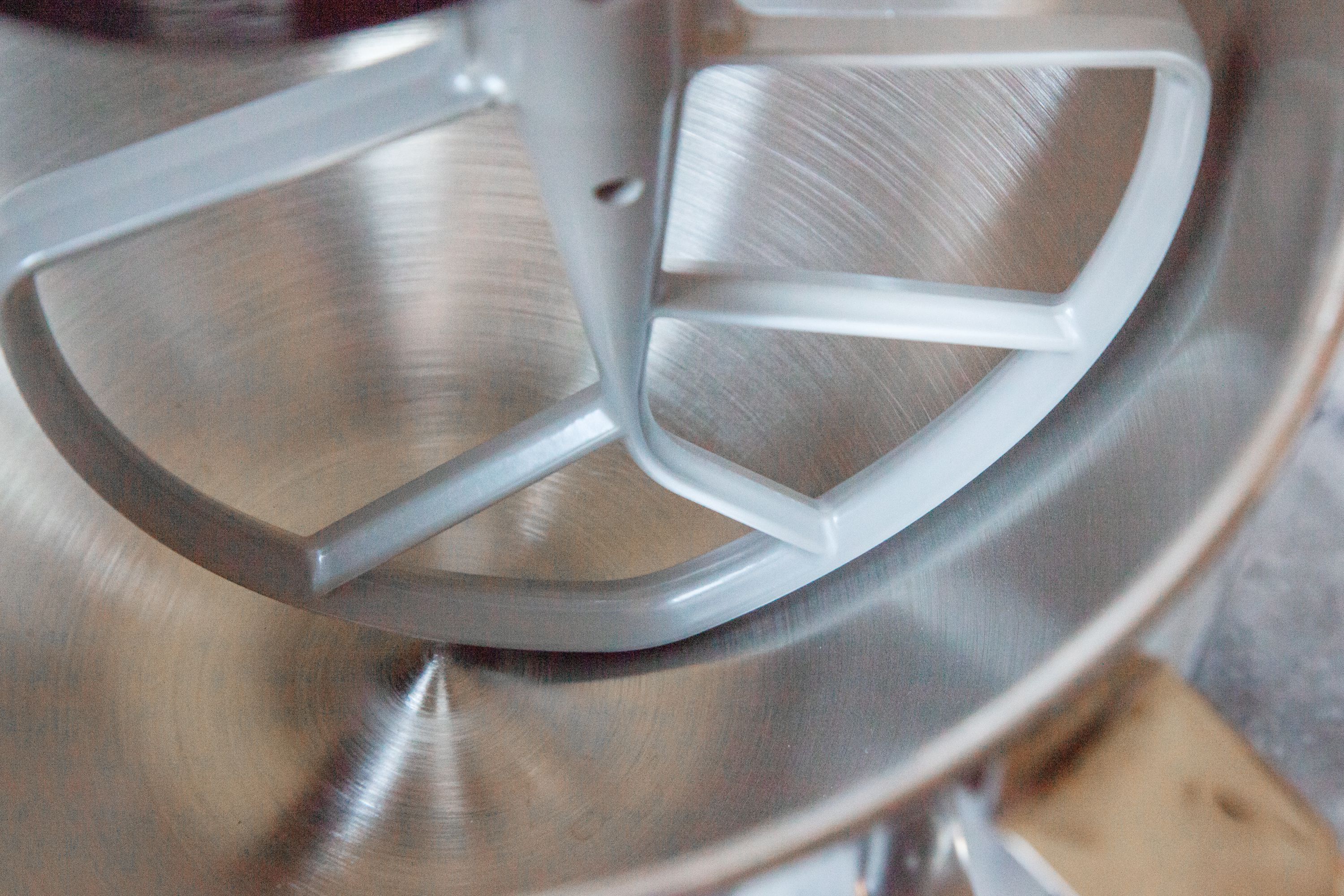 A closeup look at a stand mixer fitted with a paddle attachment
