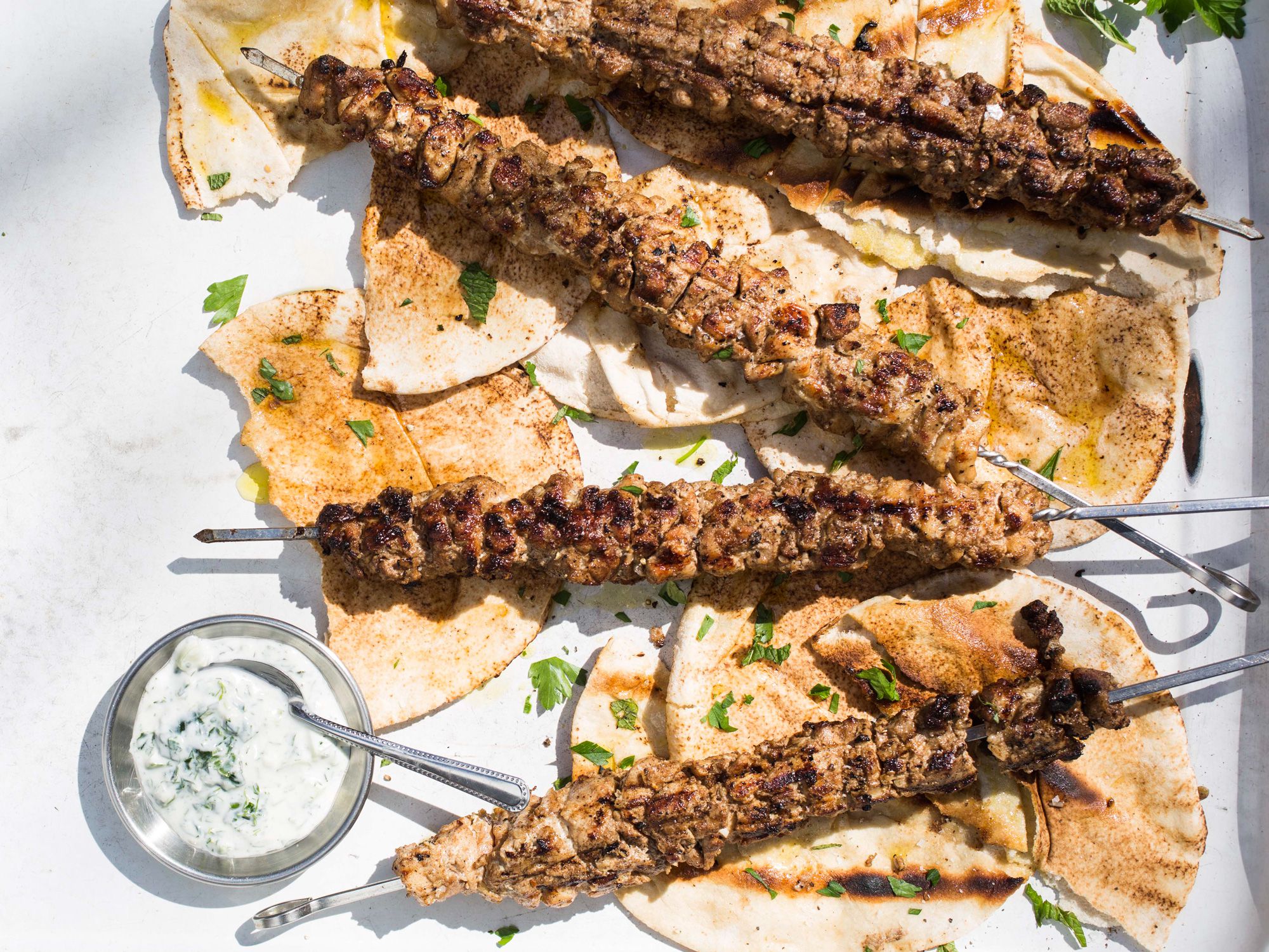 Soak up the flavorful juices of these Mediterranean-spiced chicken skewers by resting them on grilled pita during the final stages of cooking in this dish from Ana Sortun, who uses yogurt's natural acidity to tenderize tough cuts of meat. Get the recipe for <a href="https://www.saveur.com/chicken-shawarma-recipe/">Yogurt-Marinated Chicken Shawarma</a>