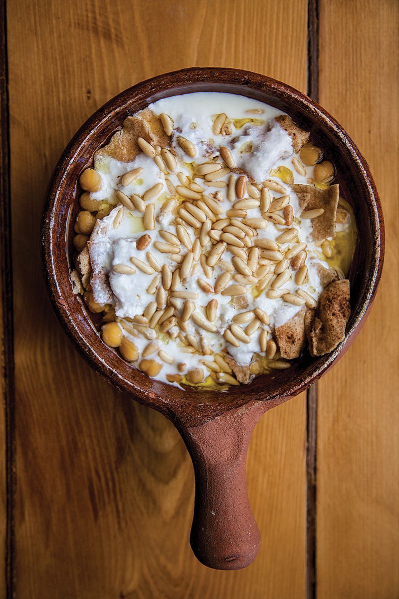 Across the Levant, you will find variations on fatteh, dishes built on toasted or fried day-old bread. The term comes from the Arabic word "fatta", meaning to crumble bread. In this Lebanese version from author Fouad Kassab's mother Isabelle, brown butter tops a layered dish of baked pita and chickpeas tossed with spiced yogurt. To save time, soak the chickpeas in water <em>and</em> baking soda: the alkilinity of the soda breaks down the beans' cellular walls and can reduce cooking time by thirty five minutes. Get the recipe for <a href="https://www.saveur.com/article/recipes/fattet-hummus-chickpeas-with-pita-and-spiced-yogurt/">Fattet Hummus (Chickpeas with Pita and Spiced Yogurt)</a>