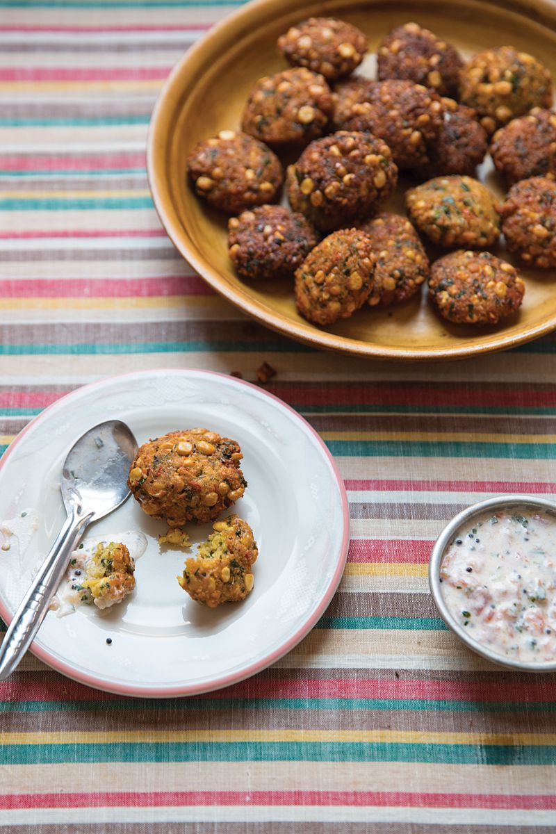 In Tamil-speaking households, a combination of fritters with sauce is referred to as vadai pachadi. Served for weddings and religious holidays, these spicy fritters get their signature crunch from yellow split peas and are topped with a creamy, tangy yogurt-tomato sauce. Get the recipe for <a href="https://www.saveur.com/article/recipes/vadai-pachadi-pigeon-pea-fritters-with-yogurt-tomato-sauce/">Pigeon Pea Fritters with Yogurt-Tomato Sauce (Vadai Pachadi)</a>