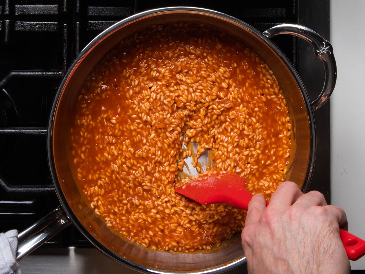 Stirring risotto in a saucepan