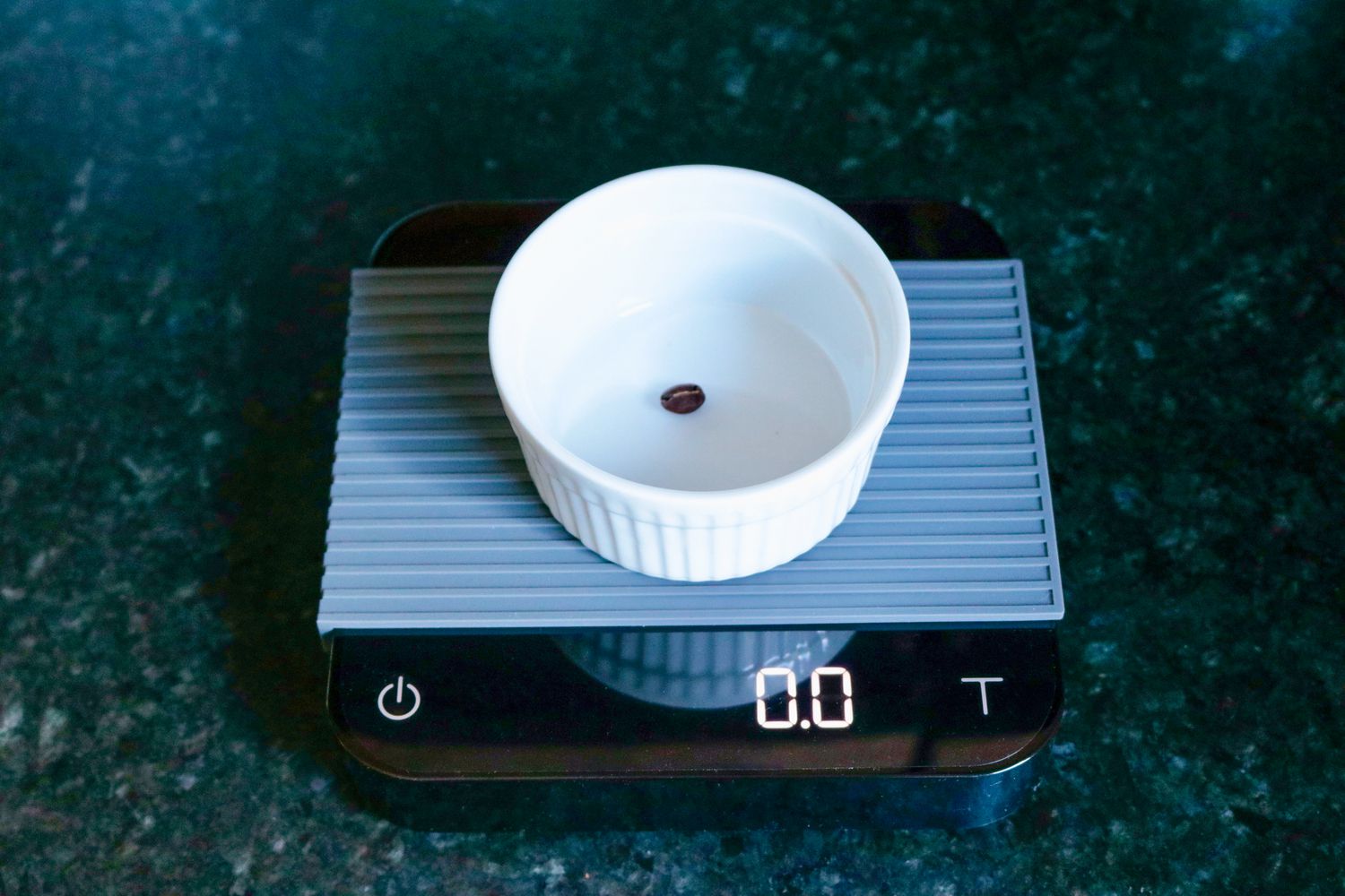 weighing a single coffee bean in a ramekin on the acaia pearl coffee scale.
