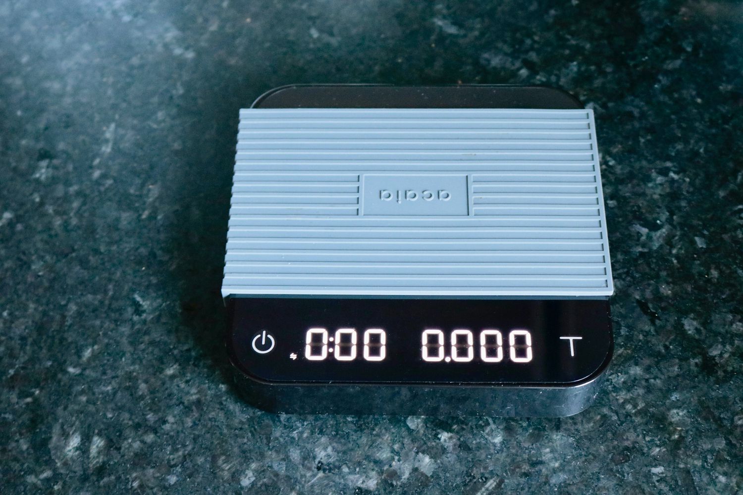 the acaia pearl scale on a granite countertop