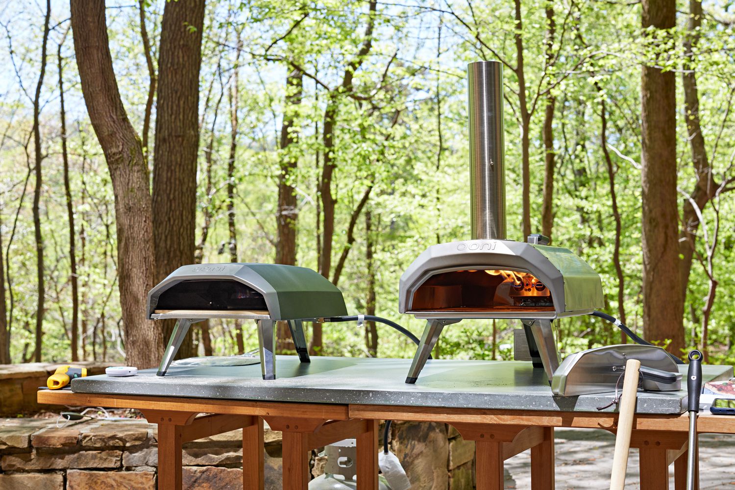 two ooni pizza ovens on a stone countertop