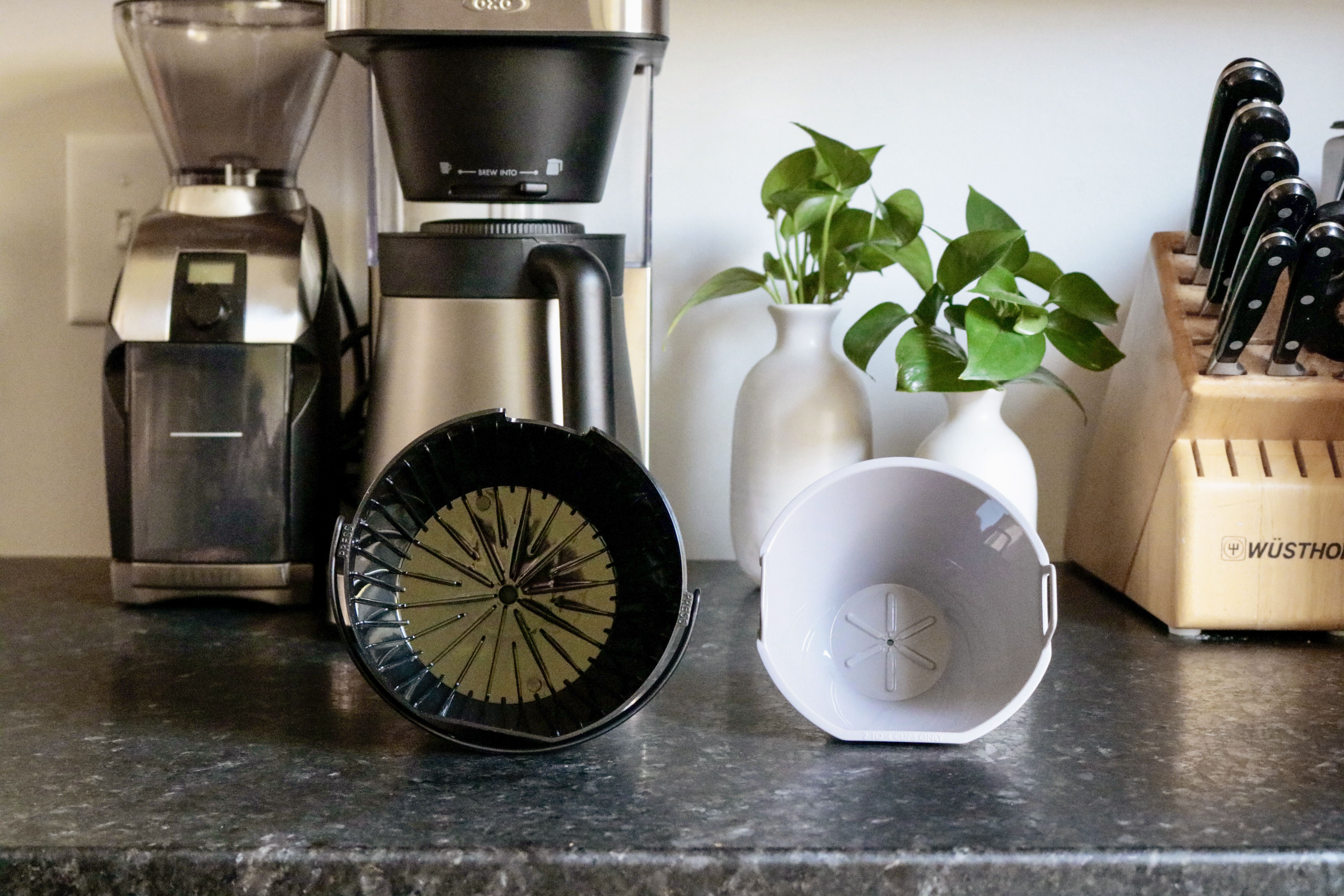one small and one larger filter basket side by side on a grey countertop