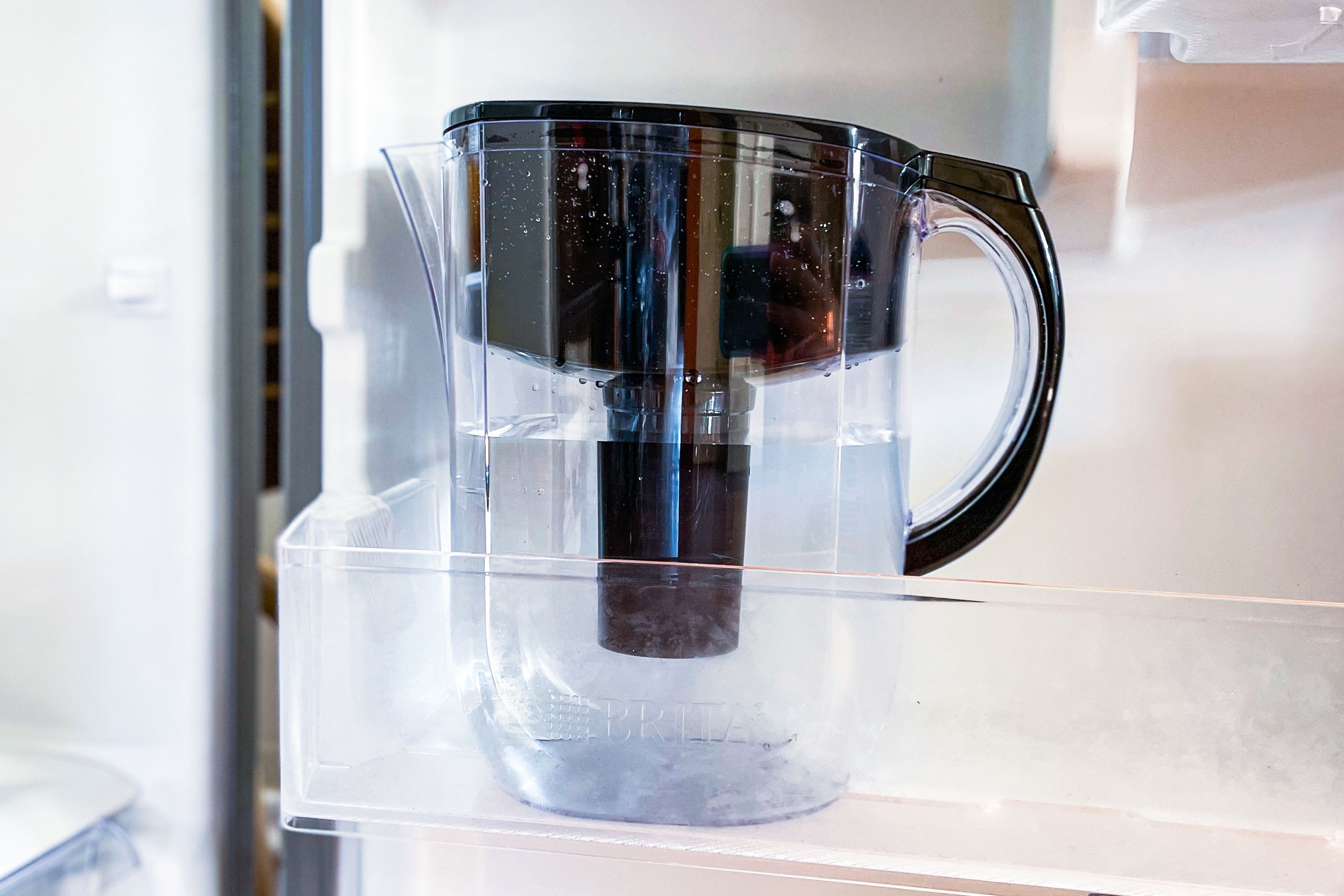 the brita pitcher in the side door of a refrigerator.