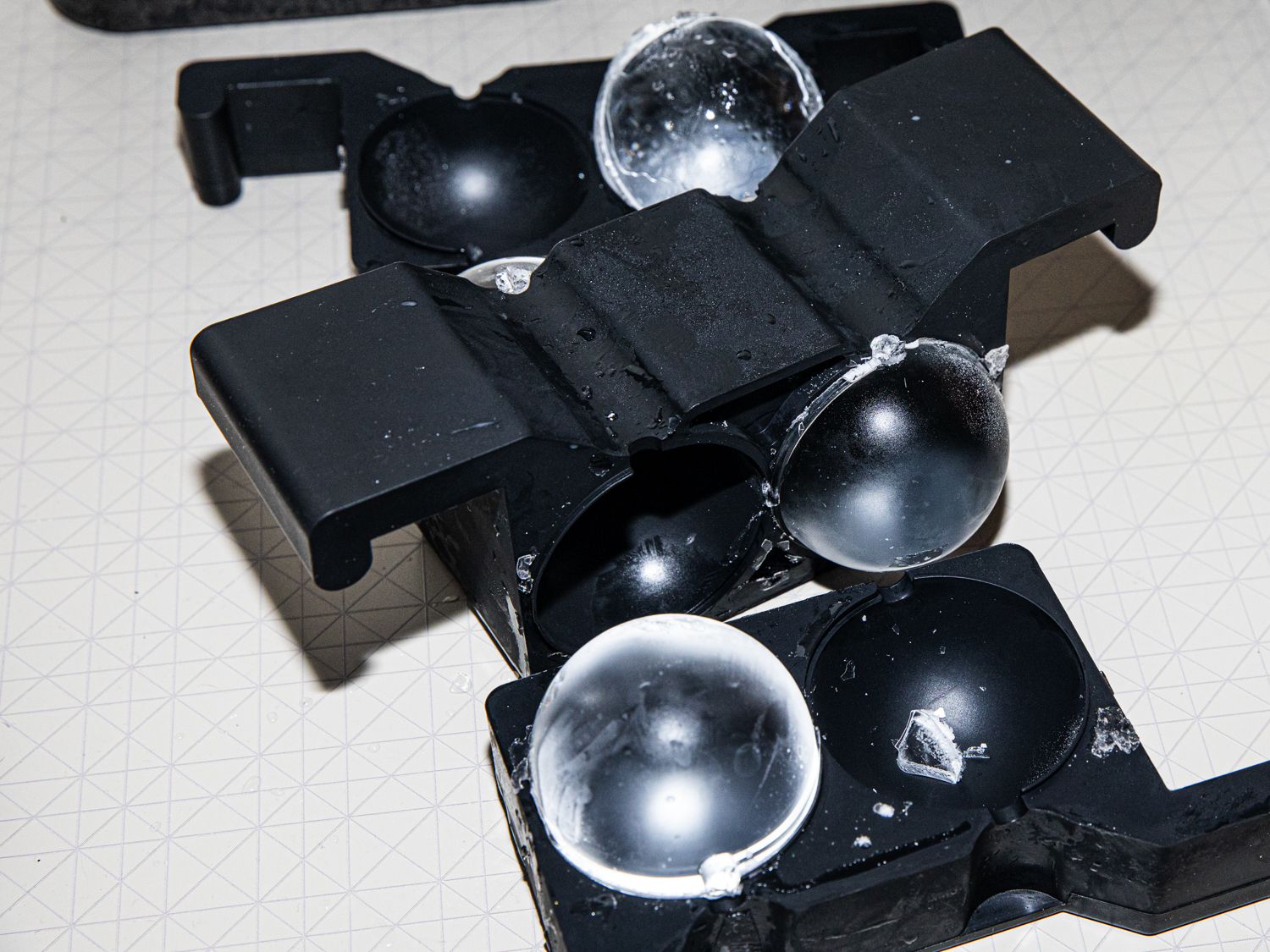 A look at sphere ice being unmolded from a plastic tray