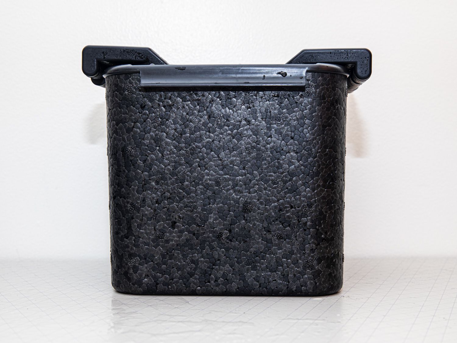 A front-on look at the Tinana clear ice maker sitting on a white surface