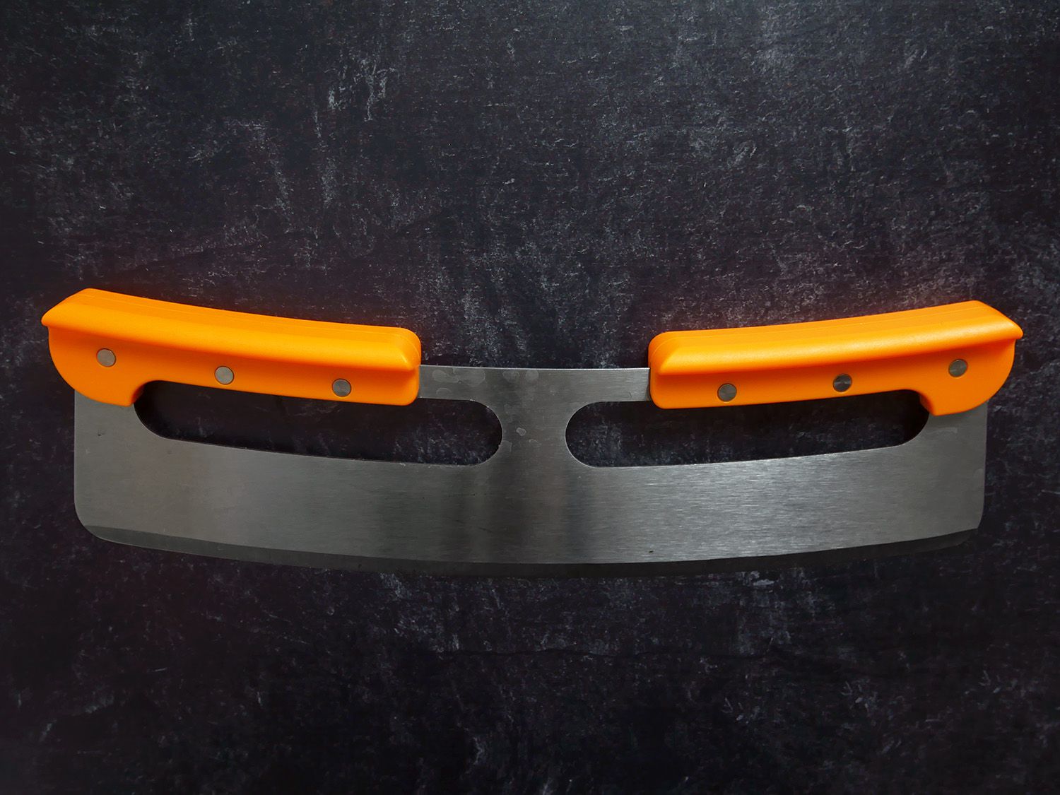 the original pizza cutter on a black countertop