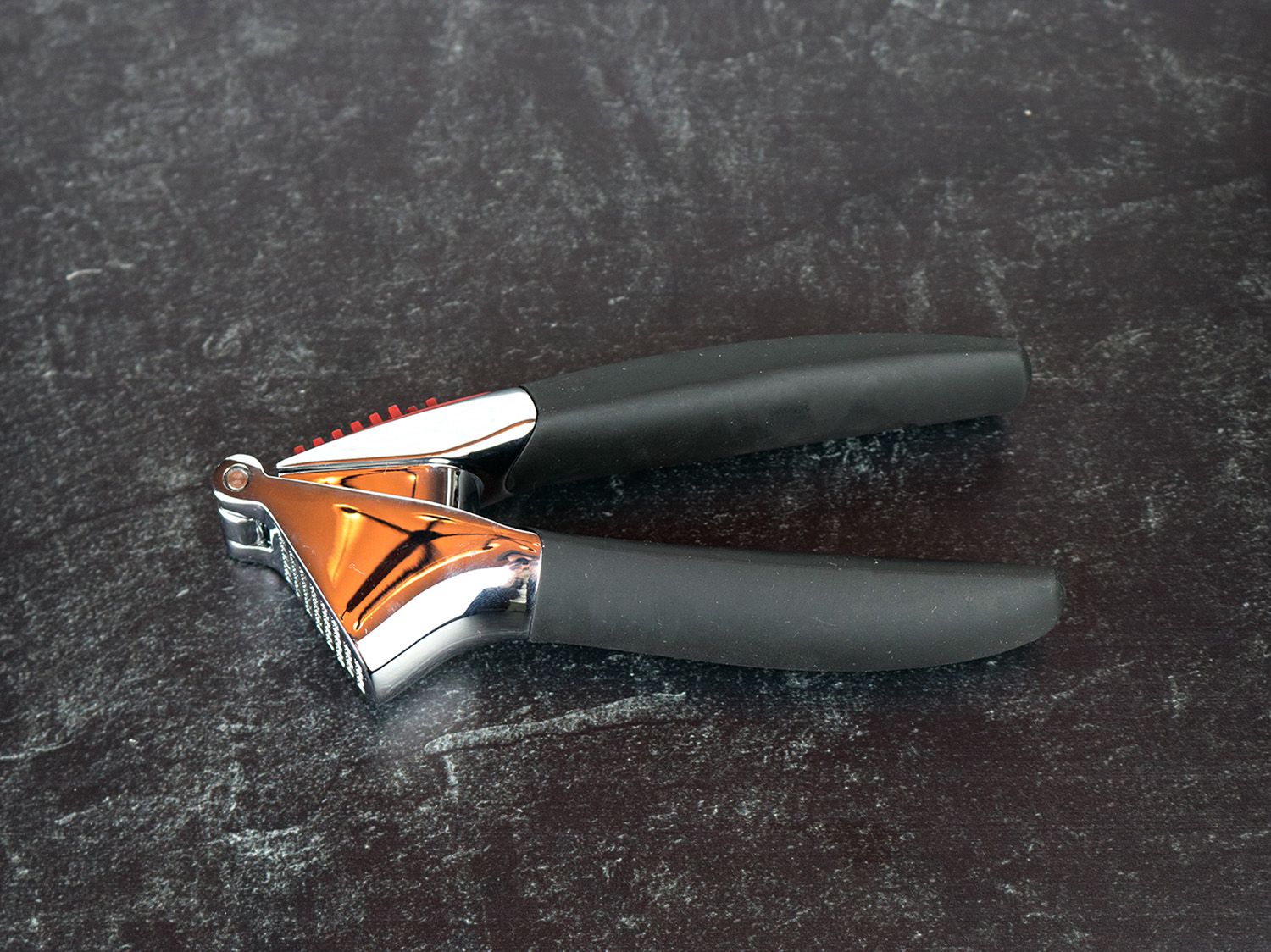 the OXO Good Grips garlic press resting on a counter